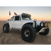 White truck with red flag driving under KC HiLiTES Universal Pro6 Gravity LED light bar