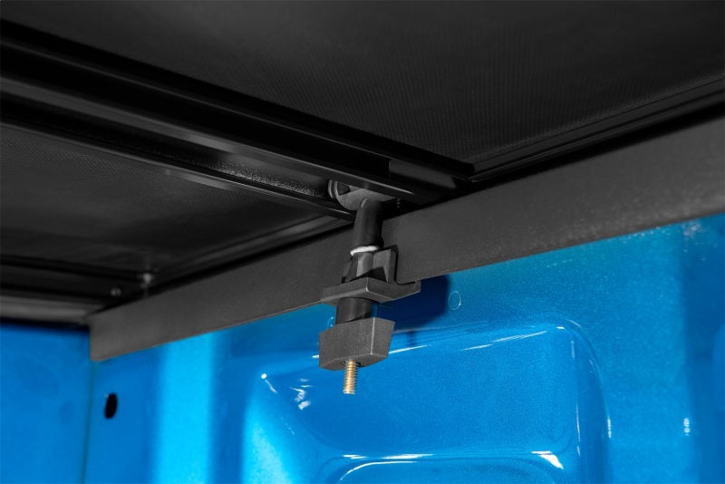 Close-up of door latch on blue plastic door for lund genesis tri-fold tonneau cover