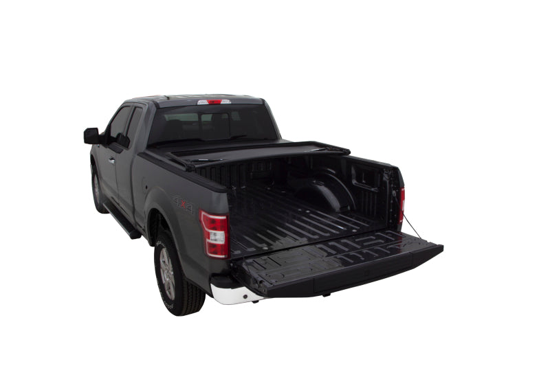 Black lund genesis tri-fold tonneau cover for toyota tacoma with bed rack on truck