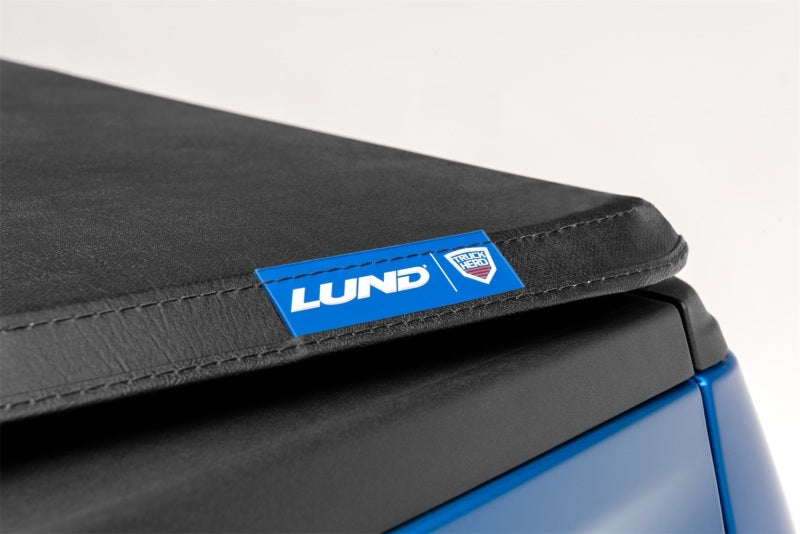 Lund genesis tri-fold tonneau cover in black for toyota tacoma with seat cushion