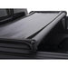 Black car with roll bar and lund genesis tri-fold tonneau cover for toyota tacoma