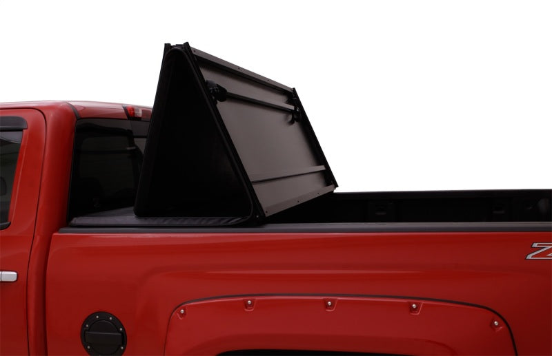Lund hard fold tonneau cover on red truck with doors open