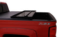 Black lund hard fold tonneau cover on toyota tacoma truck bed