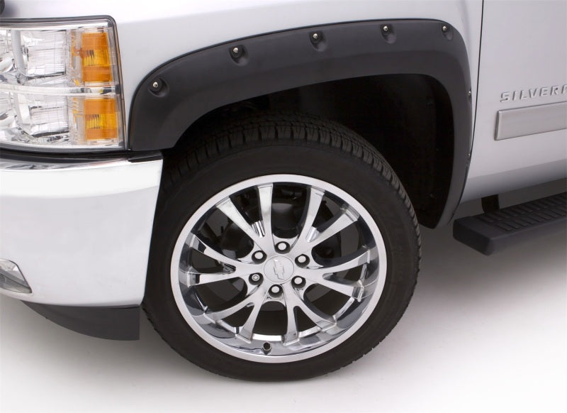 White truck with black rim and tire featuring lund’s rx-rivet style fender flares