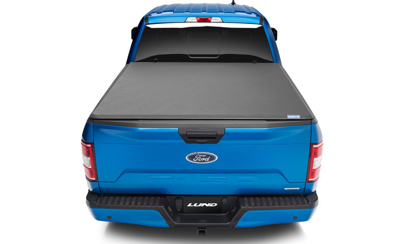 Lund genesis elite tri-fold tonneau cover on blue toyota tacoma truck - black