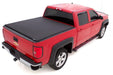 Red truck with black lund genesis elite tri-fold tonneau cover - black for toyota tacoma (5ft. Bed)