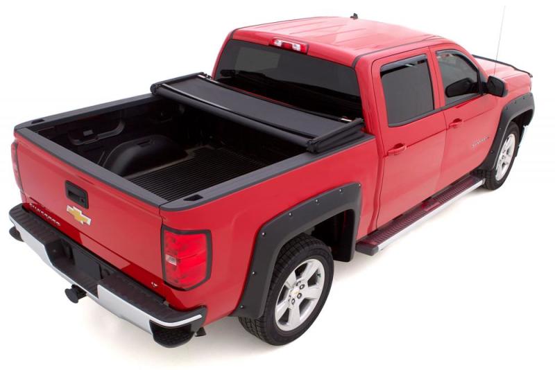 Red truck with lund genesis elite tri-fold tonneau cover - black