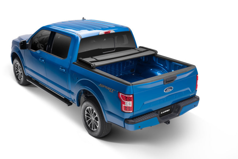 Blue ford f-150 truck with lund genesis elite tri-fold tonneau cover - black