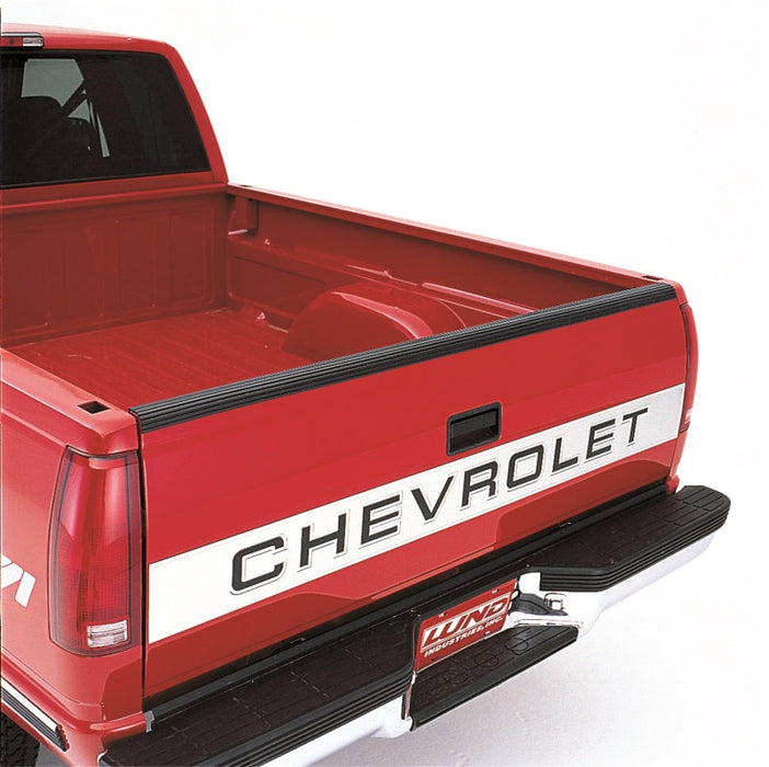 Red truck with black stripe on lund universal pickup tailgate protector - black