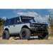 Front end view of white truck with black bumper featuring Mickey Thompson Baja Legend MTZ Tire.