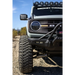 Close-up image of a truck with a light on and a bumper mounted, showcasing the Mickey Thompson Baja Legend MTZ Tire.