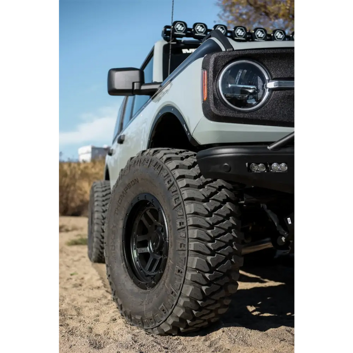 White jeep with black bumper featuring Mickey Thompson Baja Legend MTZ tire.