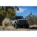 Jeep driving through muddy Baja Legend MTZ trail.