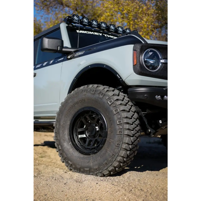 White truck with black tire cover featuring Mickey Thompson Baja Legend MTZ Tire.