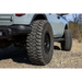 Front end of silver truck with large tire - Mickey Thompson Baja Legend MTZ Tire.