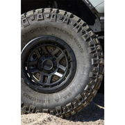 Front wheel and tire of a jeep featuring Mickey Thompson Baja Legend MTZ Tire.