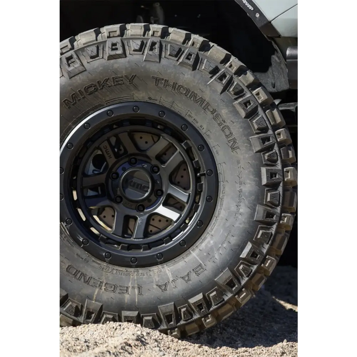 Front wheel and tire of a jeep featuring Mickey Thompson Baja Legend MTZ Tire.