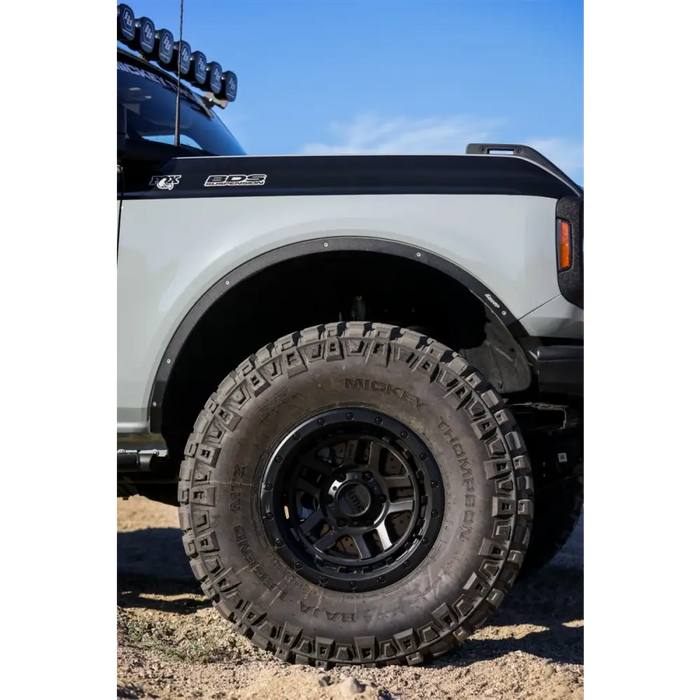 White truck with black wheels featuring Mickey Thompson Baja Legend MTZ tires.