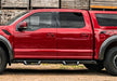 Red toyota tacoma double cab parked in front of barn with n-fab epyx cab length running boards