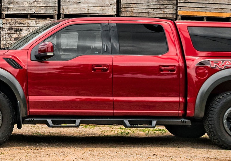 Red truck parked in front of a barn - n-fab epyx 2018 jeep wrangler jl 4dr suv - full length - tex. Black