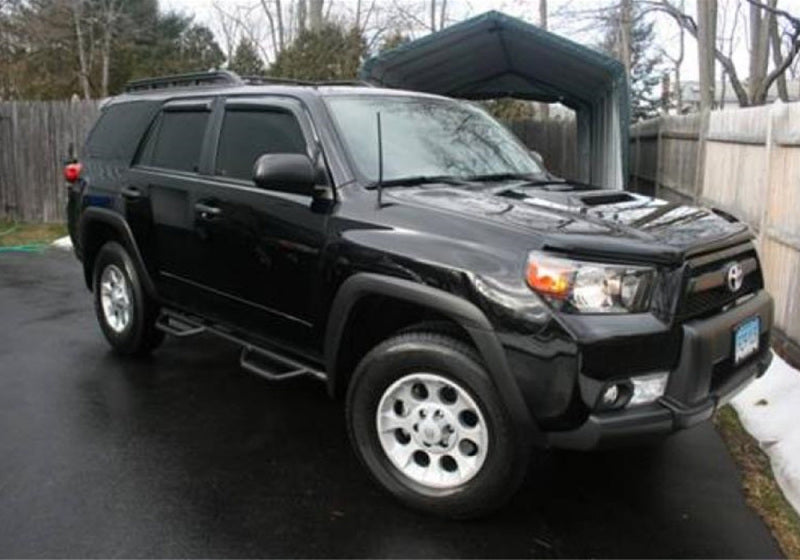 Black toyota suv with n-fab nerf steps parked in driveway