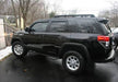 Black toyota 4runner suv with n-fab nerf steps parked in a lot