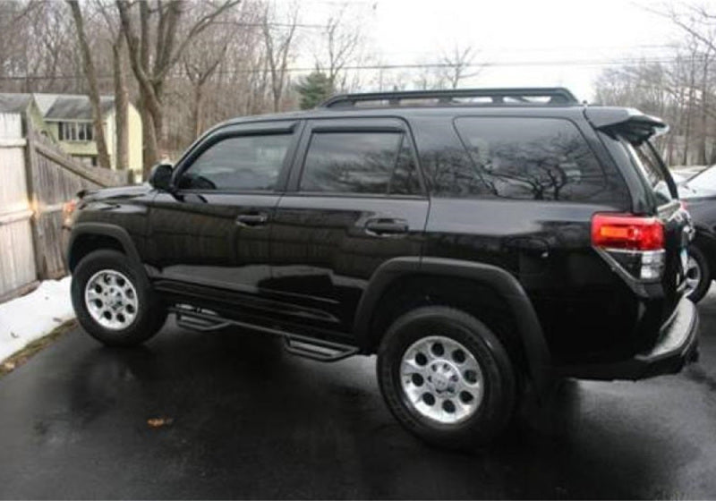 Black toyota 4runner suv with n-fab nerf steps parked in a lot