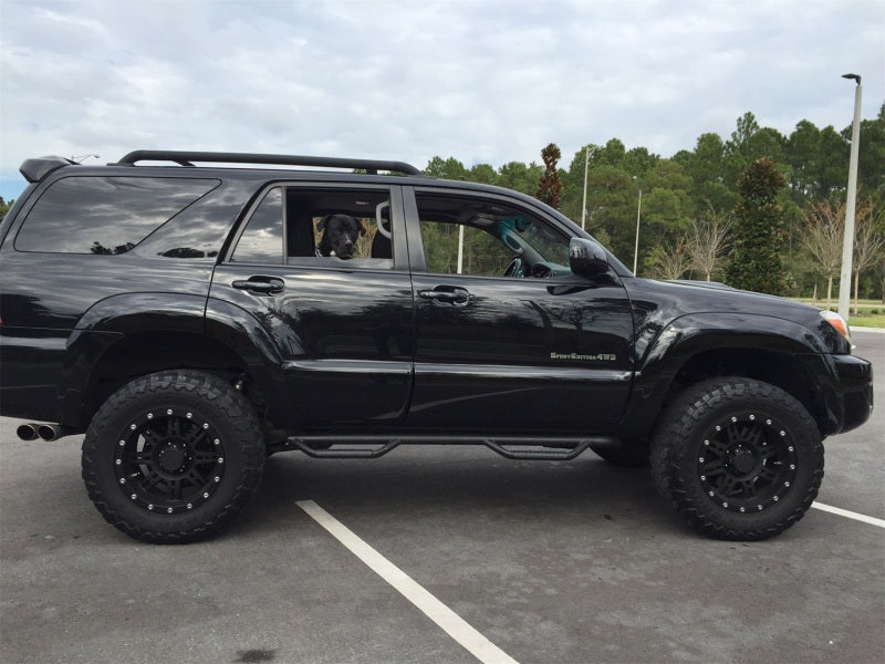 Black truck with big tire featuring n-fab nerf step for 03-09 toyota 4 runner suv 4 door - tex. Black - wheel nerf