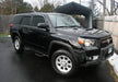 Black toyota 4runner suv with n-fab nerf step in a driveway - w2w - 3in