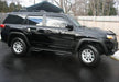 Black toyota 4runner suv with n-fab nerf step, w2w, 3in - parked in lot