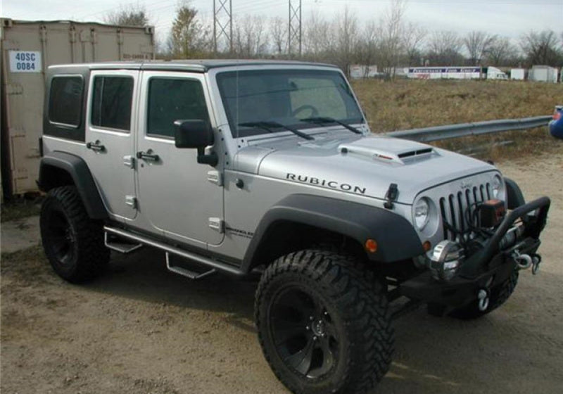 Silver jeep parked in lot with n-fab nerf step 07-17 jeep wrangler jk 4 door all-tex black - w2w -