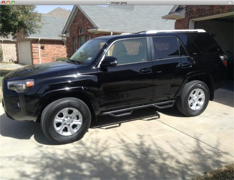 Black toyota suv parked in front of house - n-fab nerf step 14-18 toyota 4 runner suv - wheel nerf steps