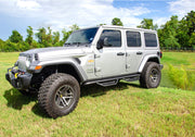 White jeep wrangler jl 4dr suv parked in field - n-fab podium lg - step design