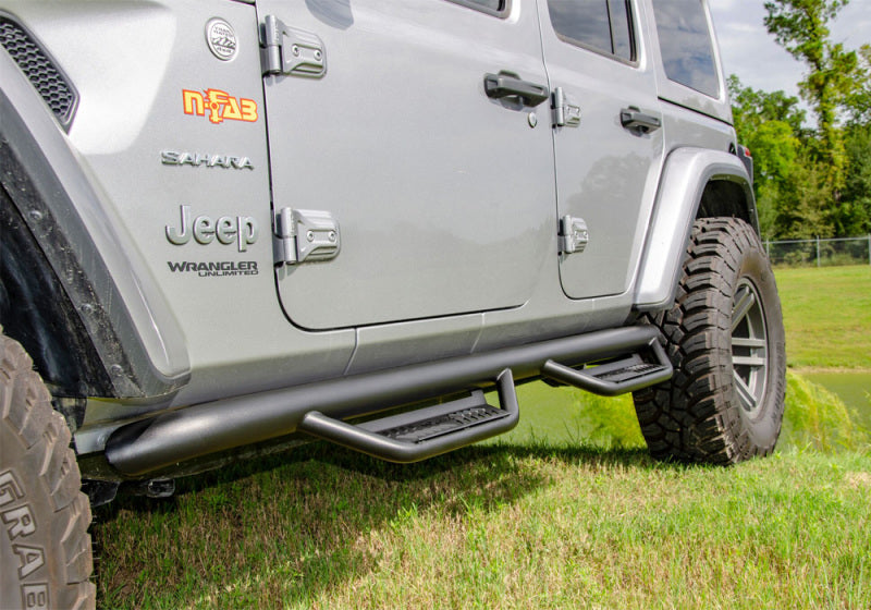 Front end view of gray jeep wrangler jt 4dr with n-fab podium lg step design in tex. Black stainless steel