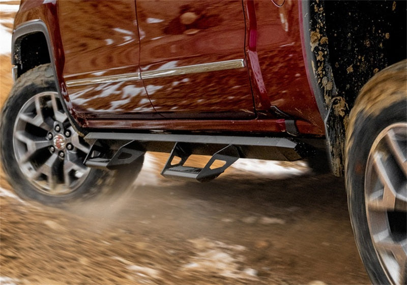 N-fab predator pro step system on red truck driving on dirt road