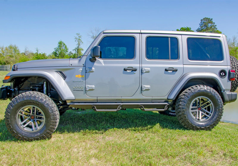 N-fab predator pro step system on jeep wrangler in field