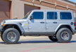 N-fab predator pro step system on silver jeep parked in front of building