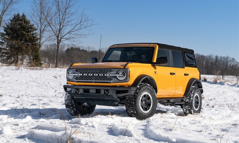 N-fab predator pro step system on a yellow truck parked in the snow