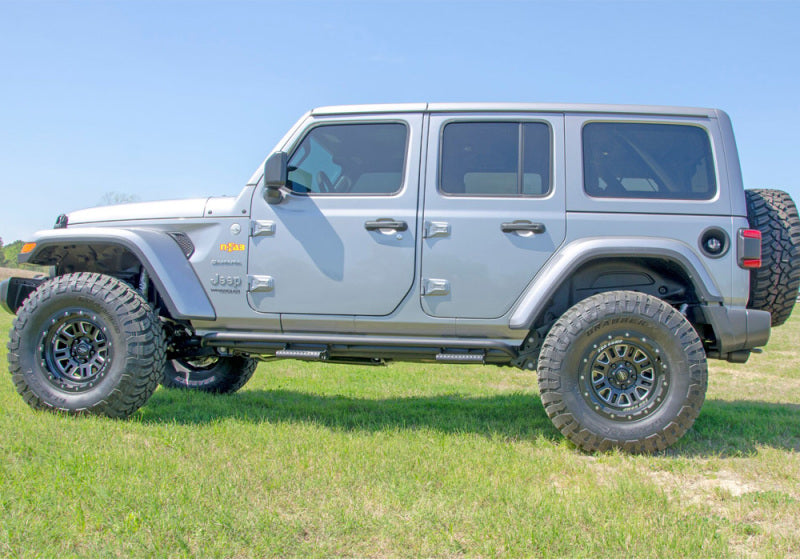 2018 jeep wrangler jl parked in field with n-fab rock rails