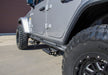 Gray jeep with black tire cover featuring n-fab rkr rails for 2018 jeep wrangler jl 4 door - gloss black - 1.75in