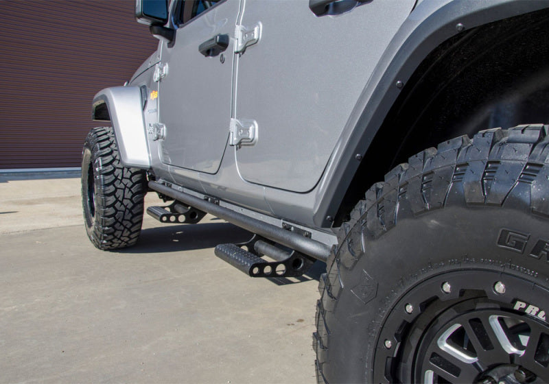 Gray jeep with black tire cover featuring n-fab rkr rails for 2018 jeep wrangler jl 4 door - gloss black - 1.75in