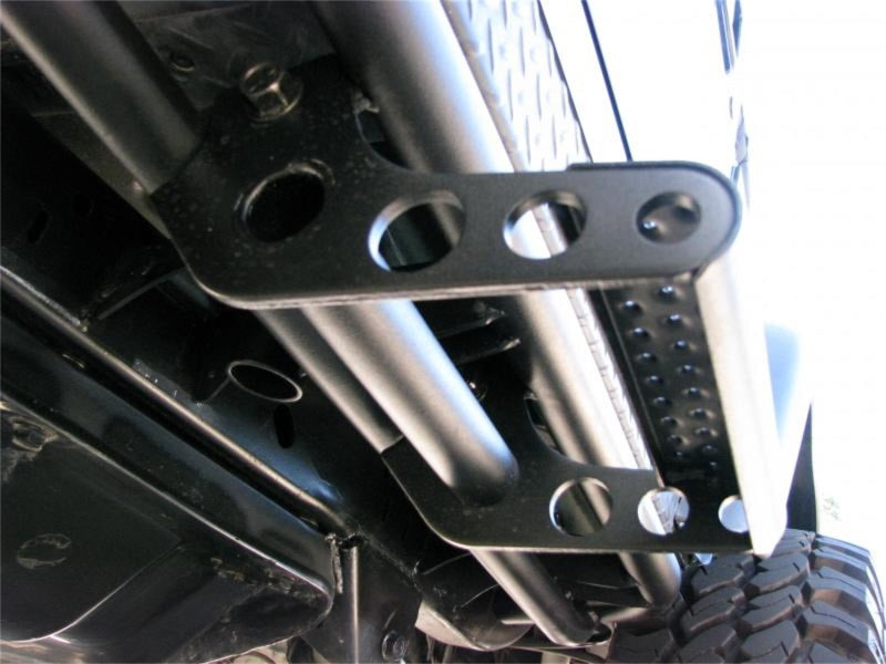 Close-up of car suspension in n-fab rkr universal detachable step - pair - tex. Black