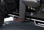 Man sitting in the back of a truck with n-fab rs nerf steps for jeep wrangler jl 4dr
