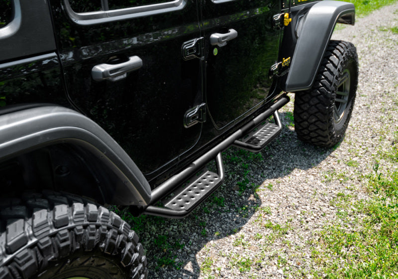 Black tire cover on jeep wrangler jl with n-fab rs nerf step, cab length nerf steps