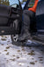 Man in black boots sitting on back of black car - n-fab trail slider steps textured black