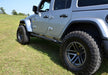 N-fab trail slider steps in textured black on jeep wrangler in field