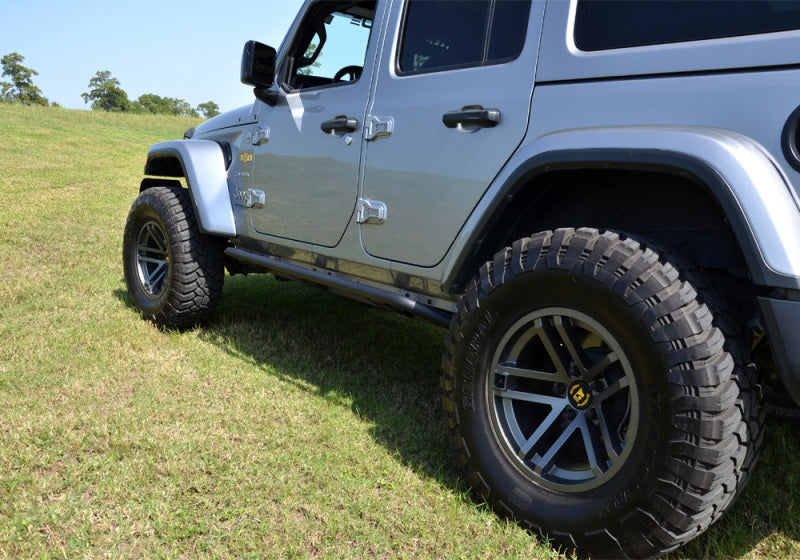 N-fab trail slider steps in textured black on jeep wrangler in field