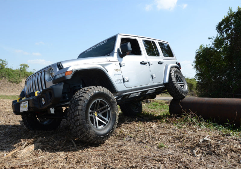 White jeep parked in field - n-fab trail slider steps for jeep wrangler jl 4 door suv in textured black