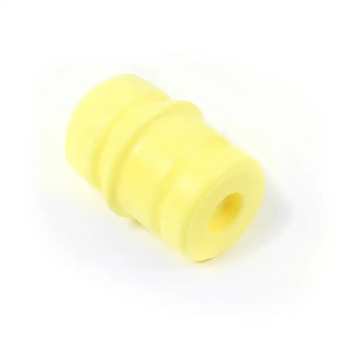 Omix Bump Stop yellow plastic tube on white background