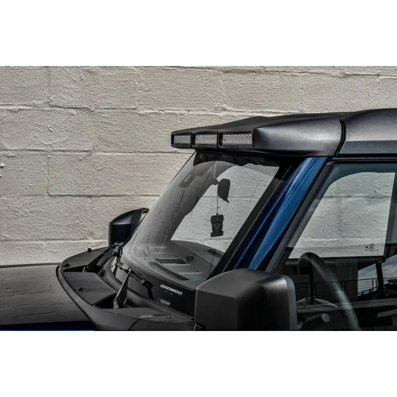 Black car with blue roof, black window - Oracle 2021+ Ford Bronco Integrated Windshield Roof LED Light Bar System.